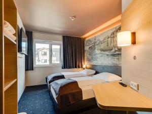 Postel nebo postele na pokoji v ubytování B&B Hotel Oldenburg