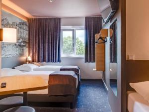 Postel nebo postele na pokoji v ubytování B&B Hotel Oldenburg