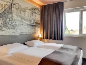Postel nebo postele na pokoji v ubytování B&B Hotel Oldenburg