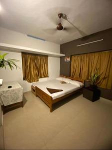 a bedroom with a large bed and a ceiling at The Varkala Retreat Villa in Varkala +22 photos