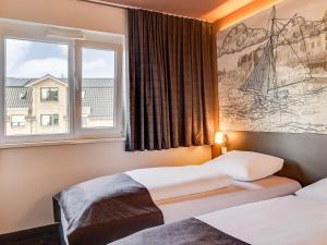 Postel nebo postele na pokoji v ubytování B&B Hotel Oldenburg