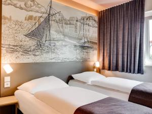 Postel nebo postele na pokoji v ubytování B&B Hotel Oldenburg