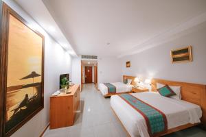 Postel nebo postele na pokoji v ubytování Petro Hotel
