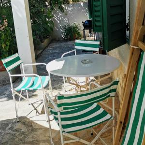 a table and chairs sitting on a patio at Secret Garden Apartment Center Opatija with private parking space in Opatija