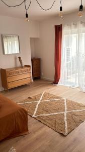 a bedroom with a bed and a large window at Appartement pour 2 in Le Blanc