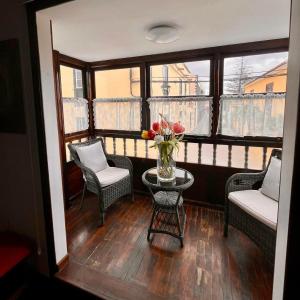 a balcony with a table and chairs and a vase of flowers at Zen Den Coliving - For Digital Nomads Only in Arona +8 photos