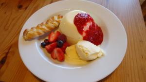 a plate of fruit and ice cream on a table at Ashdowns of Dover in Dover