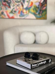 a book and sunglasses on top of a table at Penthouse Lebada Lake View in Pantelimon