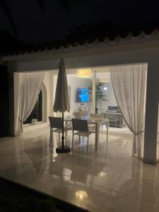 a living room with a table and chairs and a dining room at Sun Club Playa del Ingles in Playa del Ingles