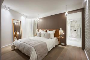 a bedroom with a large bed and a bathroom at First Croisette in Cannes