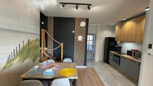 a kitchen with a table and a dining room at APARTAMENT Św Jerzego in Białystok