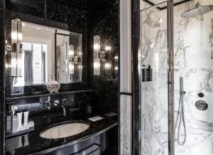 a black and white bathroom with a sink and a shower at Hotel Scalinata Di Spagna in Rome +284 photos