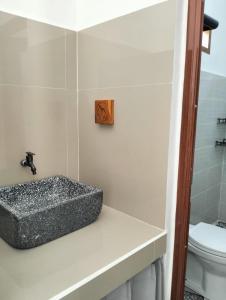 a bathroom with a sink and a toilet at LilyPad guest house in Kuta Lombok