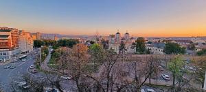 a view of a city at sunset with cars at Central Apartments' Privat-Sauna free Parking AmurResidence FamilyConcept in Iaşi