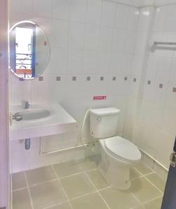 a bathroom with a toilet and a sink and a mirror at Pichayapa Place in Ban Pa Sang (1)