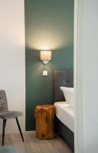 a bedroom with a bed and a table and a chair at Prime Park Deluxe Apartment Aschaffenburg in Aschaffenburg