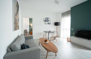 a living room with a couch and a table at Prime Park Deluxe Apartment Aschaffenburg in Aschaffenburg