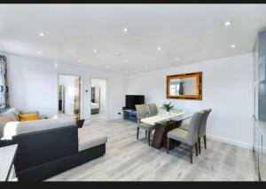 a living room with a couch and a dining room at Windmill Villa in Warsop