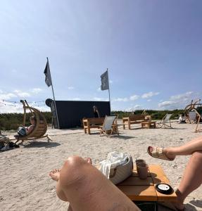 a group of people sitting in chairs on the beach at Harlehaus Nina in Friedrichsschleuse