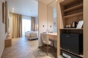 a living room with a desk and a television in a room at Villa Sophia in Kalliópi