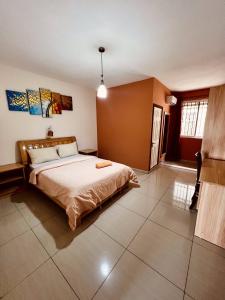 a bedroom with a large bed in a room at Vintage Lodge in Quatre Bornes