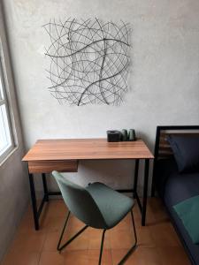 a desk and a green chair in a room at Eisei House in Jakarta +25 photos