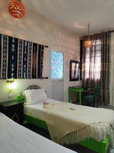Postel nebo postele na pokoji v ubytování Hôtel Ayachi