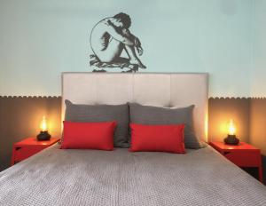 a bedroom with a large bed with two red lamps at Ocean View Studio in Playa del Ingles in San Bartolomé +5 photos