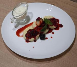 a white plate with food on a table at Sport Hotel 2 in Cherkasy
