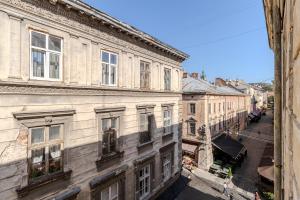 a view of an old building from a window at TUT Staroevreyska С Apartment in Lviv