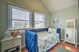 a bedroom with a blue bed and a window at Dreamcatchers in North Beach