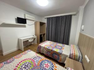 Postel nebo postele na pokoji v ubytování Hotel Dila