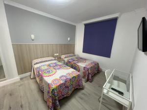 Postel nebo postele na pokoji v ubytování Hotel Dila