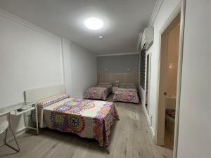 Postel nebo postele na pokoji v ubytování Hotel Dila