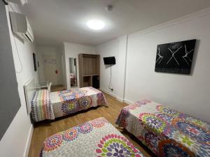 Postel nebo postele na pokoji v ubytování Hotel Dila