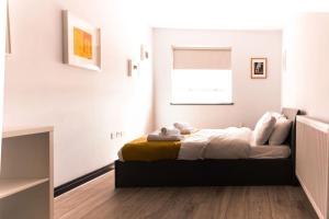 a bedroom with a bed in a room with a window at The Seaview Apartment - Margate Beach - By Goldex Coastal Breaks in Kent