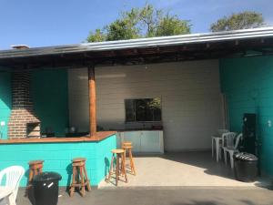 un bar all'aperto con sgabelli e una griglia di Sítio Recanto do Pardal a Santa Rita de Caldas