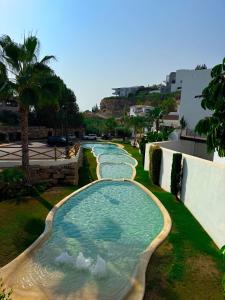 a row of swimming pools in a resort at Oceanview luxury Penthouse in Estepona