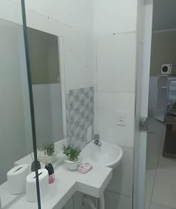 a white bathroom with a sink and a mirror at Apto 4 Bom Preco in Riacho Fundo