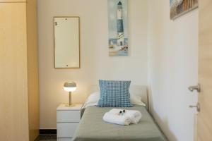 a bedroom with a bed with two towels on it at "Lomellina Bay" 10 minuti a piedi dal mare in Varazze +62 photos