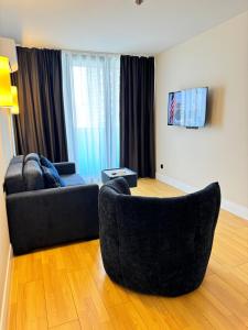 a living room with a couch and a chair at EVIS LTD apartments Batumi 2 in Angisa