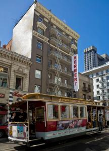 a street scene with a bus and a building at Herbert Hotel in San Francisco