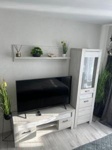 a living room with a flat screen tv on a entertainment center at Luxusný Apartmán Váh in Hlohovec