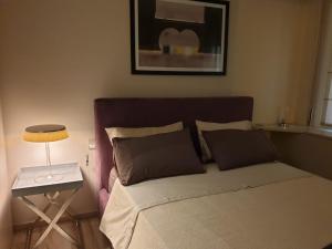 a bedroom with a bed and a table with a lamp at Casa delle Farfalle in Bologna