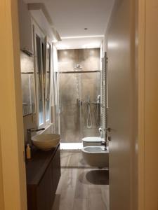 a bathroom with two sinks and a shower at Casa delle Farfalle in Bologna