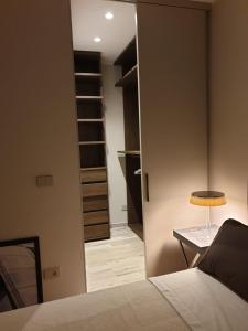 a bedroom with a closet with a bed and a lamp at Casa delle Farfalle in Bologna +3 photos