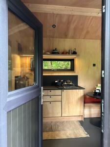 an open door to a kitchen in a tiny house at Digital Detox cabin in Westmeath