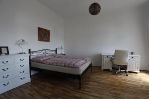 ウィーンにあるCasa Nostra - Sonnige Wohnung direkt am Augartenのベッドルーム1室(ベッド1台、ドレッサー、デスク付)