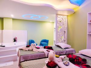 a room with two beds and a tub and a sink at Hotel The Al Aqsa in Chittagong +43 photos