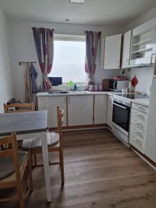 a kitchen with a table and a table and a dining room at Unnuisarfik Iglo Nuuk in Nuuk